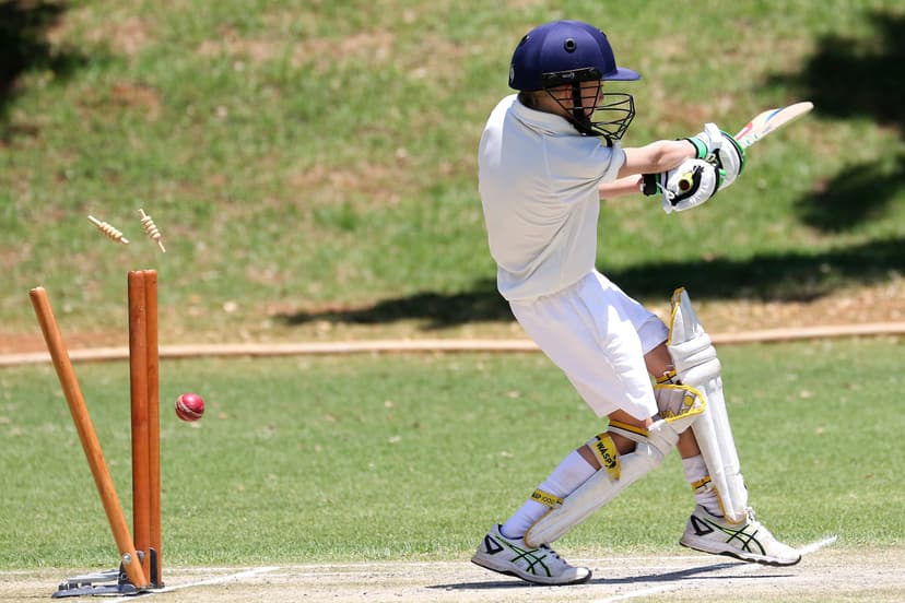 The bails fly as a junior batter is bowled